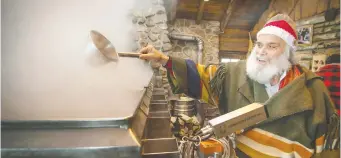  ?? PETER McCABE ?? Pierre Faucher checks the boiling sap as it is made into maple syrup at Sucrerie de la Montagne in Rigaud, west of Montreal.