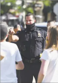  ?? Tyler Sizemore / Hearst Connecticu­t Media ?? Stamford police Capt. Diedrich Hohn gives a warning to the Latham Abolition Camp to stop blocking traffic at Latham Park in Stamford July 15.