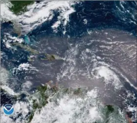  ?? NOAA VIA AP ?? In this geocolor image GOES-16 satellite image taken Sunday at 15:00 UTC, shows Tropical Storm Beryl, center right, moving across the Lesser Antilles in the eastern Caribbean Sea, and Tropical Storm Chris, top left, off the U.S. East Coast.