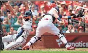  ?? Jeff Roberson / The Associated Press ?? Atlanta’s Nick Markakis (left) scores past St. Louis Cardinals catcher Carson Kelly during Sunday’s game in St. Louis.