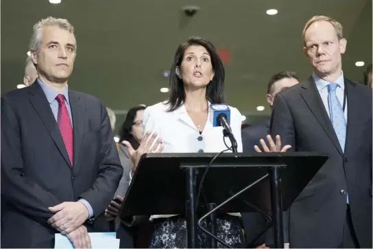  ??  ?? Flanked by the French Deputy Representa­tive to the UN Alexis Lamek, left, and British Representa­tive to the UN Matthew Rycroft, right, US Ambassador to the UN Nikki Haley speaks to reporters at the UN headquarte­rs, on Monday in New York City. (AFP)