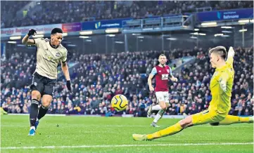  ??  ?? Game changer: Anthony Martial fires the ball past Nick Pope to break the deadlock against Burnley and put Manchester United on the road to another three points at Turf Moor