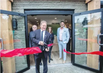  ?? PHOTOS BY DARREN STONE, TIMES COLONIST ?? Langford Mayor Stew Young cuts the ribbon at the opening of The Scene’s presentati­on centre on Peatt Road on Friday. Below, Young looks at a model of The Scene’s two towers — 18 and 24 storeys high.