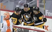  ?? KEITH SRAKOCIC — THE ASSOCIATED PRESS ?? Pittsburgh’s Evgeni Malkin, center, celebrates with Sidney Crosby, left, and Bryan Rust after scoring a first-period goal on Flyers goalie Brian Elliott at PPG Paints Arena Saturday.