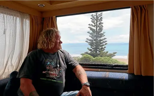  ?? CHLOE RANFORD/LDR ?? Mark Wills, who is organising a petition against a proposed quad bike ban in Marlboroug­h, looks out the window of his campervan at Marfells Beach.