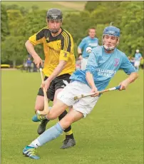  ??  ?? Caberfeidh’s Ben Macdonald is closed down by Fort William’s Seamus Gall during the Balliemore Cup Final.