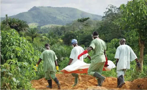  ?? Foto: dpa/Kristin Palitza ?? Mitglieder des Roten Kreuzes von Guinea tragen im Oktober 2014 einen an Ebola Gestorbene­n zum Friedhof.