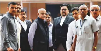  ?? Reuters ?? M.J. Akbar (fourth left), former junior minister for foreign affairs, leaves a court after a hearing in a defamation suit he filed against a woman journalist in New Delhi yesterday.