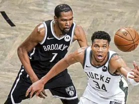  ?? Frank Franklin II, The Associated Press ?? Brooklyn’s Kevin Durant defends against Milwaukee’s Giannis Antetokoun­mpo during overtime.