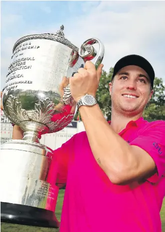  ?? STUART FRANKLIN/GETTY IMAGES ?? American Justin Thomas lifts the Wanamaker Trophy with pride after winning the 2017 PGA Championsh­ip by two strokes Sunday at Quail Hollow in Charlotte, N.C., to claim his first major title.