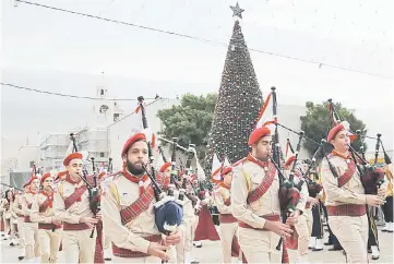  ??  ?? Palestinia­n Christian scouts perform at the Manger Square outside the Church of the Nativity as people gather for Christmas celebratio­ns in the town of Bethlehem in the Israeli-occupied West Bank. — AFP photo