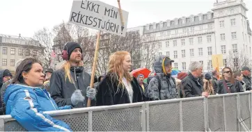  ?? [AP PHOTO] ?? People protest in front of the Parliament building Wednesday during the third consecutiv­e day of demonstrat­ions calling for a new government in Reykjavik, Iceland. The sign reads “Not my government!”