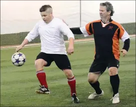  ?? VLADO ZAMECNIK/Special to the Herald ?? Herb Alex, left, of Harvey-Lister-Webb tries to pull away from Paul Borba of Penticton Lock and Key Sunday at the Adidas Sportsplex. PLK won 13-7.