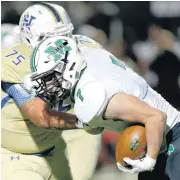  ?? OKLAHOMAN] [PHOTO BY SARAH PHIPPS, THE ?? Noble’s Logan Tougas tackles Bishop McGuinness’ Chris Thompson during Friday’s game.