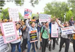  ?? — BUNNY SMITH ?? People hold placards and participat­e in a protest opposing the arrests this week of five prominent rights activists in New Delhi on Thursday.