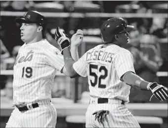  ?? FRANK FRANKLIN II/AP PHOTO ?? The Mets’ Jay Bruce and Yoenis Cespedes celebrate after scoring on an RBI double during the third inning of Friday’s game against Colorado at Citi Field. The Mets won, 14-2.