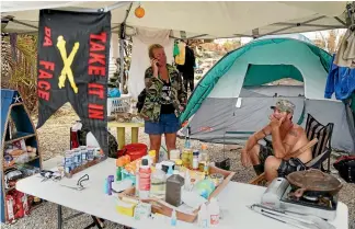  ?? REUTERS ?? Two friends made homeless by Hurricane Irma shelter at their campsite in Cudjoe Key, Florida. Thousands of people in the state are still seeking temporary or permanent shelter a week after the devastatin­g storm.