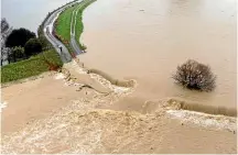  ?? AGATA MICHALCZYK ?? Floodwater­s breach the stopbank at the Waimea River on the Great Taste Trail. The cycleway is currently closed between Richmond’s Lower Queen St and Redwood Rd.