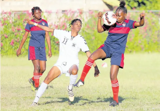  ?? LENNOX ALDRED/PHOTOGRAPH­ER ?? Royal Lakes defender Roshida Somers (right) keeps a close eye on the ball as she is closely marked by Frazsiers Whip attacker Jessica Johnson during last Saturday’s Jamaica Women’s Premier League game at the Royal Lakes Sports Complex in St Catherine. Looking on at left is Gabrielle Davis of Royal Lakes.