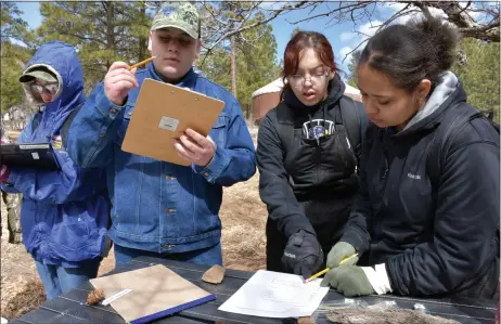  ?? COURTESY STACI MATLOCK, NMFWRI ?? A team of Peñasco High School students work on a forestry test as part of the Northern N.M. Regional Envirothon competitio­n March 24 at Collins Lake Ranch in Cleveland, N.M. The state Envirothon competitio­n is April 14-16 at the Glorieta Adventure Camp. Winners are eligible for the Internatio­nal Envirothon competitio­n in New Brunswick, Canada in July.