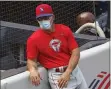  ?? KATHY WILLENS – THE ASSOCIATED PRESS ?? Phillies manager Joe Girardi leans against the stands during batting practice Monday before an exhibition game against his old team at Yankee Stadium in New York.