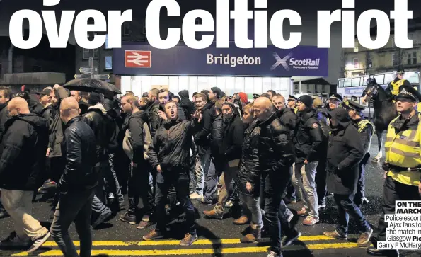  ??  ?? ON THE MARCH Police escort Ajax fans to the match in Glasgow Pic Garry F McHarg