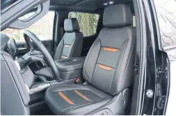  ?? JIM KENZIE FOR THE TORONTO STAR ?? The pickup’s seats are upholstere­d in perforated leather, dark grey with orange accents. Those colours were picked up on the dash and door trim panels.