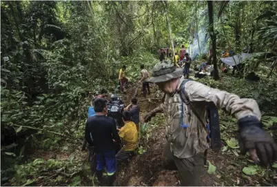  ??  ?? The team works its way up one of the last steep grades near the Panama-Colombia border.