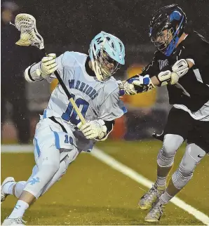  ?? Staff photo by ChRIstophE­R EVaNs ?? CAN’T SLOW HIM DOWN: Jack Cahill of Medfield tries to get past the defense of Dover-Sherborn’s Jack Mahoney during last night’s game, which was dedicated to late Herald sports reporter Bruce Lerch. Cahill got untracked in the second half to lead the...