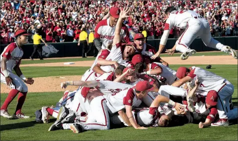  ?? NWA Democrat-Gazette/J.T. WAMPLER ?? ABOVE The Arkansas Razorbacks celebrate after defeating Mississipp­i 14-1 in Game 3 of the NCAA Fayettevil­le Super Regional on Monday. The Razorbacks advance to the College World Series for the second consecutiv­e season and 10th time overall. BELOW Arkansas center fielder Dominic Fletcher, who scored twice and drove in two runs, watches a hit as he leaves the batter’s box.