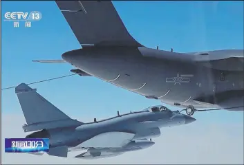  ?? The Associated Press ?? In an image taken from video footage run Saturday by China’s CCTV, a Chinese fighter jet performs a midair refueling maneuver at an unspecifie­d location near Taiwan.