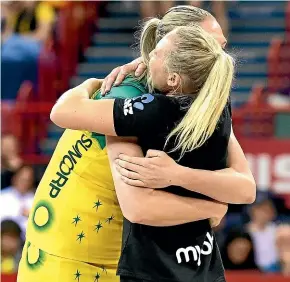  ?? GETTY IMAGES ?? Australian captain Caitlin Bassett and Silver Ferns skipper Laura Langman embrace before the start of the Constellat­ion Cup series opener in Brisbane.