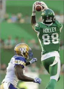  ?? MARK TAYLOR, THE CANADIAN PRESS ?? Saskatchew­an Roughrider­s wide receiver Caleb Holley goes up to make a grab during first-half CFL action at the brand-new Mosaic Stadium.