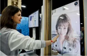  ?? — AP ?? Chloe Szulzinger demonstrat­es on CareOS, an operating system that connects multiple devices in the bathroom, during CES Unveiled at CES Internatio­nal in Las Vegas.