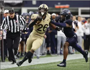  ?? (AP/Winslow Townson) ?? Army’s Kanye Udoh (26) runs past Navy’s Mbiti Williams Jr. on Saturday during a 17-11 victory at Gillette Stadium in Foxborough, Mass.