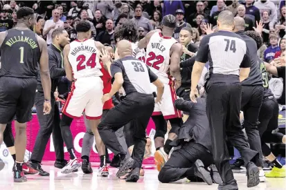  ?? Stephen Lew-USA TODAY Sports ?? Heat forward Jimmy Butler scuffles with Pelicans players during the fourth quarter of Miami’s 106-95 victory on Friday night at the Smoothie King Center. Butler, Heat center Thomas Bryant and Pelicans forward Naji Marshall and guard Jose Alvarado were ejected.