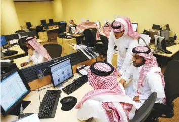  ?? Bloomberg ?? Traders at the Tadawul All Share Index in Riyadh. Saudi Arabia’s Tadawul index tumbled 7 per cent yesterday, extending the global sell-off.
