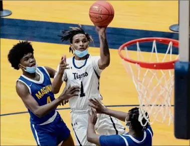  ?? James Franco / Special to the Times Union ?? Cohoes junior Royal Brown, center, helped lead his team to a 20-2 record. He also led Section II with 87 3-pointers, and establishe­d a school record with 47 points in a victory over Ichabod Crane.