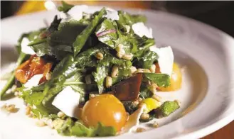  ??  ?? Baby kale, faro, spring vegetables, heirloom tomato, ricotta salata and balsamic, Recipe follows.