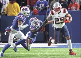  ?? JAMIE GERMANO/USA TODAY NETWORK ?? Patriots running back Brandon Bolden carries against the Bills on Monday night. The Patriots ran for 222 yards as a team in a 14-10 victory to improve to 9-4 on the season.