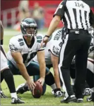  ?? PAUL CONNERS — THE ASSOCIATED PRESS ?? Eagles long snapper and sometimes TV magic star Jon Dorenbos ... he’s the guy in the middle with his head up ... says he’s ‘stoked’ about getting a contract extension from general manager Howie Roseman.