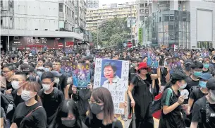  ??  ?? SPEAKING OUT: An antiextrad­ition bill protester holds a placard depicting Hong Kong’s Chief Executive Carrie Lam during a march in Hong Kong yesterday.