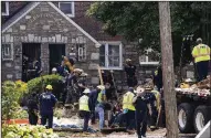  ?? AP/MATT ROURKE ?? Rescuers work to free a contractor who became trapped Thursday when a trench collapsed at a work site in a residentia­l area of Philadelph­ia.