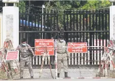  ?? — AFP photo ?? Prison security officials prepare for the release of inmates outside Insein prison in Yangon.