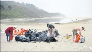  ??  ?? Alex Weston, Chris Gauthier and Kit Kuhlman help clean up Tunitas Creek Beach in 2016.The budget signed this week by Gov. Jerry Brown contains $5 million for parking, restrooms and trails at Tunitas.