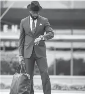  ??  ?? Left: Luqman Haskett in a suit from his spring 2020 collection. Right: A model wears a Dapper Luq shortsuit.