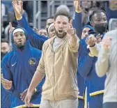  ?? JEFF CHIU — THE ASSOCIATED PRESS ?? Injured Golden State Warriors’ Klay Thompson, center, gestures during the second half of a game against the Oklahoma City Thunder last month.