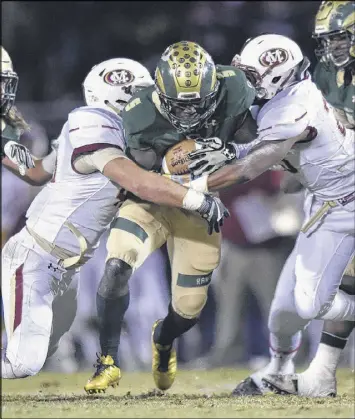  ?? DAVID BARNES / DAVID.BARNES@AJC.COM ?? Grayson running back Kurt Taylor (center) is tackled by Mill Creek defenders during the their Class AAAAAAA state semifinal game.