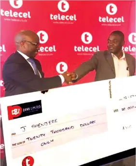  ??  ?? Telecel PR and CSR manager Francis Chimanda (left) hands over a dummy cheque for $20 000 to the winner of the MegaBucks Promotion Mr J Shenjere last week. His real prize money was sent via telecash