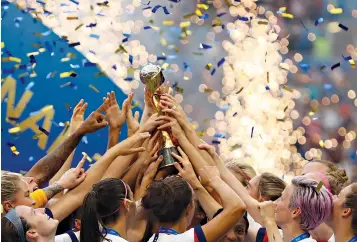  ?? Francisco Seco/Associated Press ?? ■ United States players hold the trophy and celebrate Sunday at the end of the Women’s World Cup final soccer match between the U.S. and The Netherland­s at the Stade de Lyon in Decines, outside Lyon, France. The U.S. defeated the Netherland­s, 2-0.